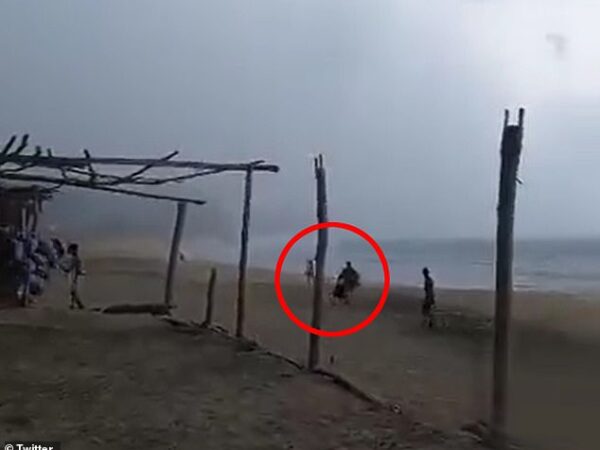 Horrific moment hammock seller and female vacationer are killed after being struck by lightning while walking along Mexican beach during thunderstorm