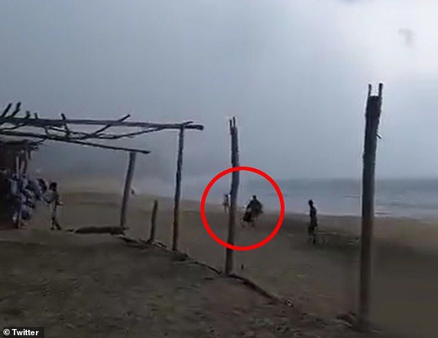 Horrific moment hammock seller and female vacationer are killed after being struck by lightning while walking along Mexican beach during thunderstorm