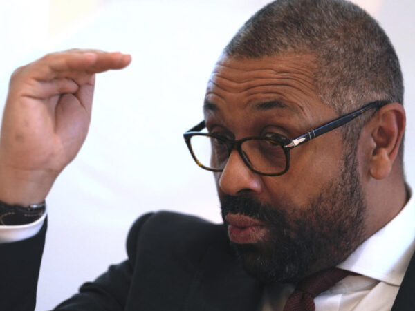 Britain’s home secretary touts UK-Rwanda migrant deportation deal during visit to Italy