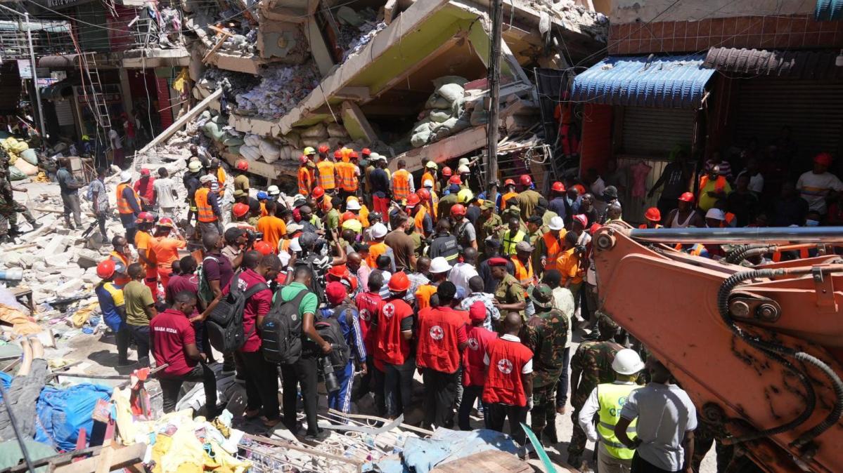 Rescuers send water through holes to building collapse trapped Rescuers send water through holes to building collapse trapped